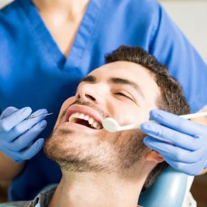 mid-adult-patient-receiving-dental-treatment-with-tools-from-female-dentist-clinic-min-min-300x300